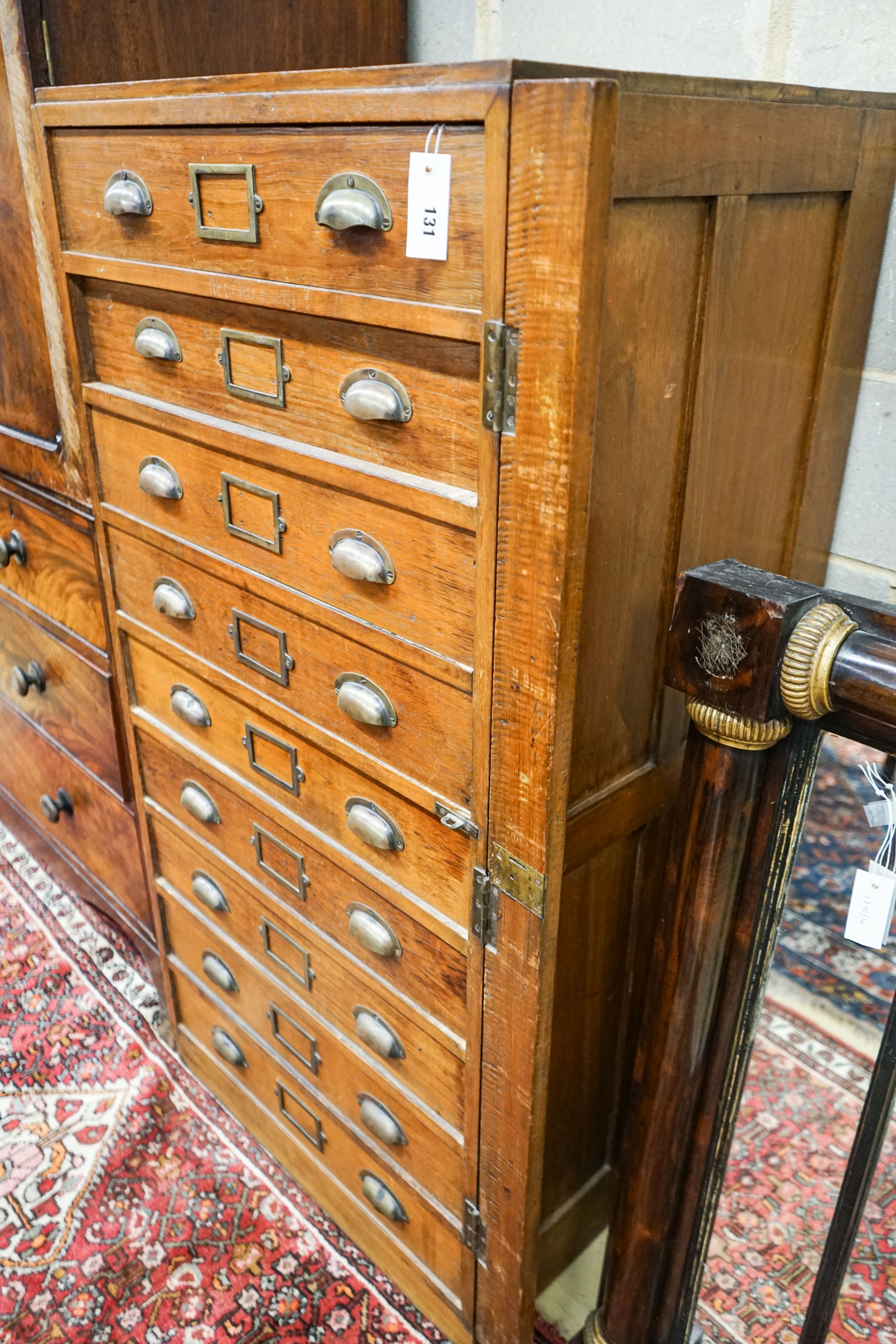 An early 20th century teak nine drawer filing chest with single locking bar, width 70cm, depth 63cm, height 142cm